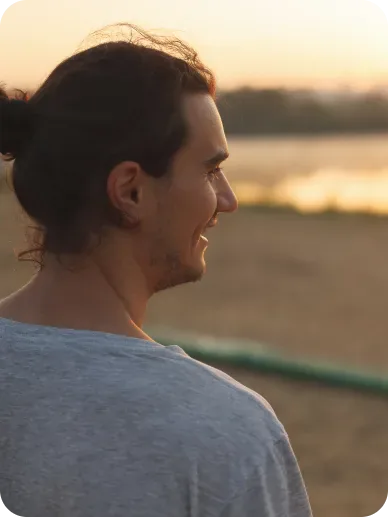 Man smiling in a sunlit park