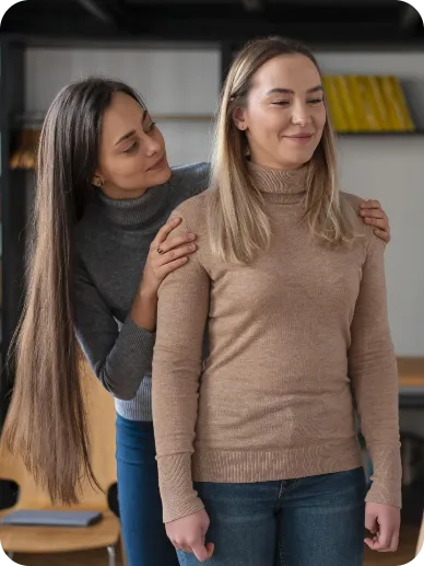 Therapist offering supportive hands on a patient's shoulders