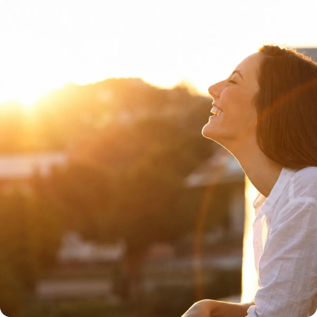 Woman standing in warm sunrise light